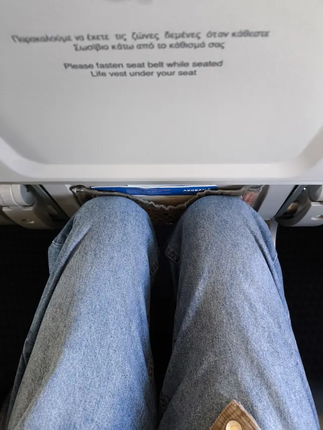 pov photo of my knees touching the seat in front of me